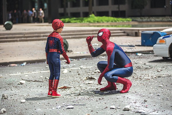 Spider-Man (right) meets a fan.
