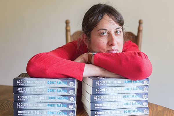 Author Dorit Sasson with copies of Accidental Soldier