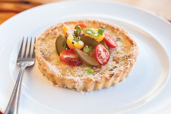 Aubergine Bistro’s ricotta tart, with corn, green beans, caramelized onions, tomato salad dill pickles and scallions