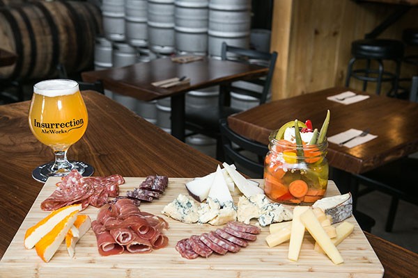 Insurrection AleWorks beer paired with a cheese and charcuterie board