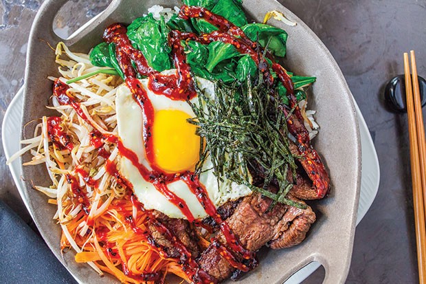 Bi bim bap with wagyu beef, carrots, bean sprouts, spinach, dippy egg, Korean BBQ sauce and rice