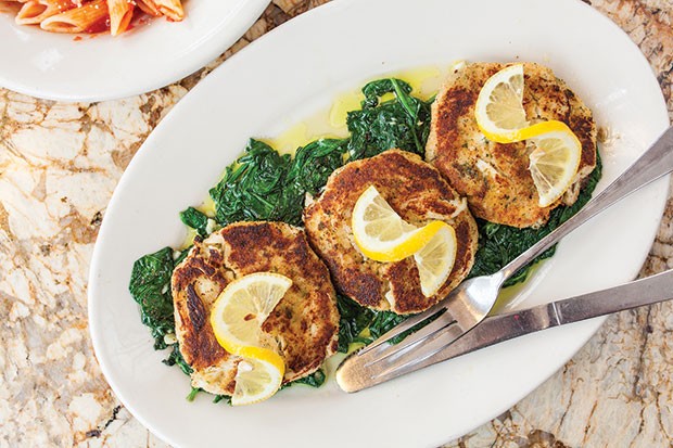 Italian-style crab cakes, served over a bed of sautéed spinach, with a side of pasta