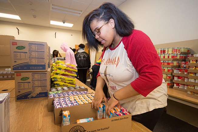 Perry High School librarian Sheila May-Stein and her students at work in the in-school food pantry