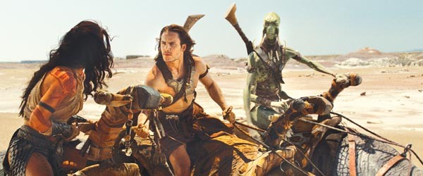 Uneasy rider: John Carter (Taylor Kitsch), flanked by two kinds of Martian