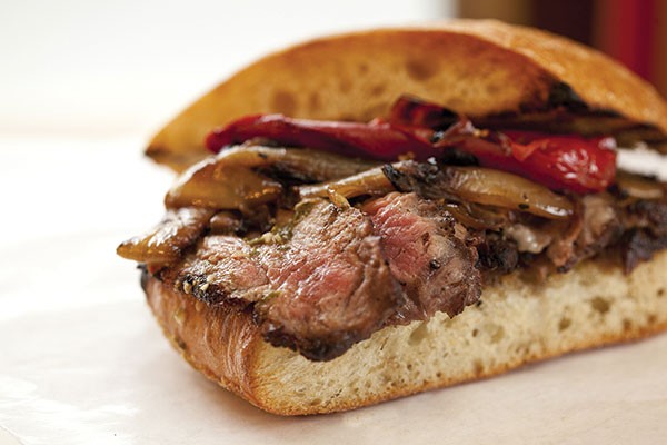 Wood-grilled beef sandwich with peppers, onions and chimichurri sauce