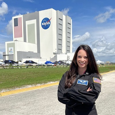 Renee Frohnert, standing in front of a NASA facility.