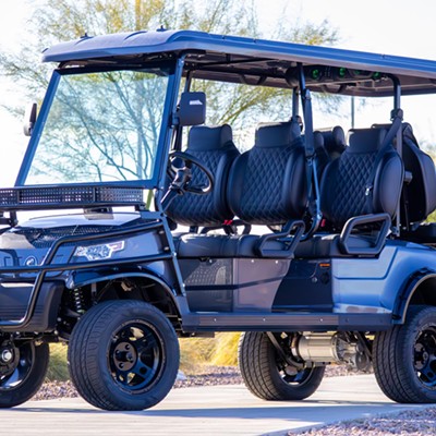 A glossy black golf cart with racing-style seating and luggage racks