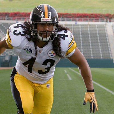 Troy Polamalu with his signature long hair in the Steelers' home white and gold uniforms