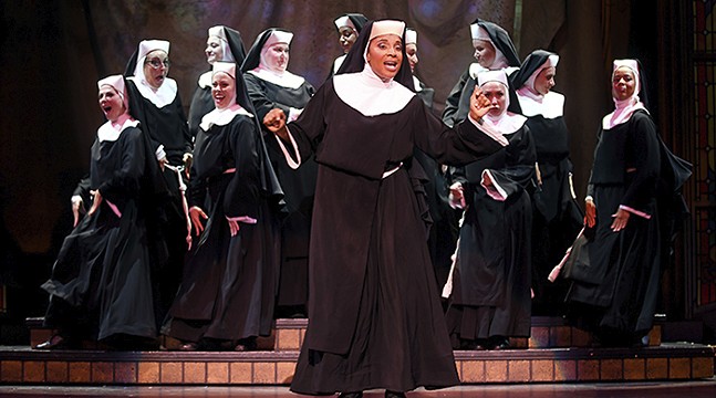 A group of nuns stand together, joyfully singing