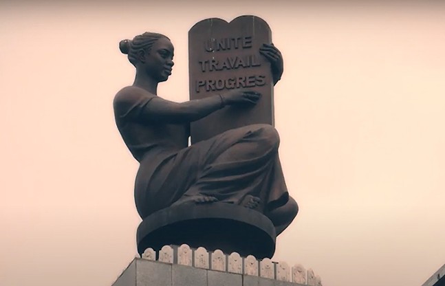 A public statue in the Republic of Congo holds a slab that reads "Unite. Travail. Progres."