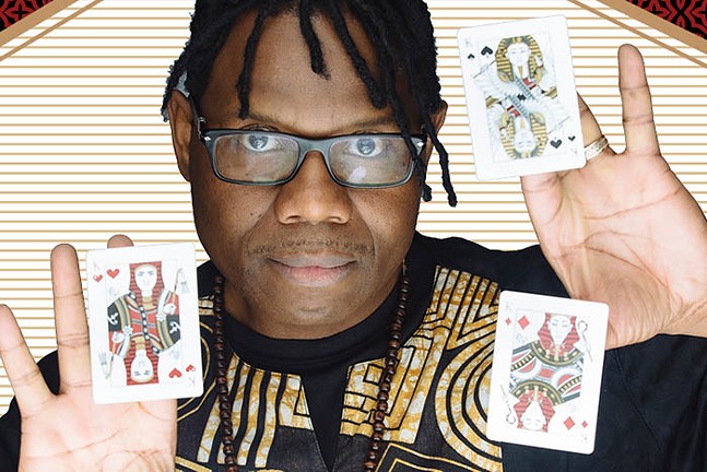 A Black man holds playing cards