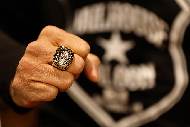 A man's fist with a large sports ring on it