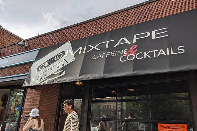 A wide shot of a black bar sign that says "Mixtape Coffee and Cocktails"