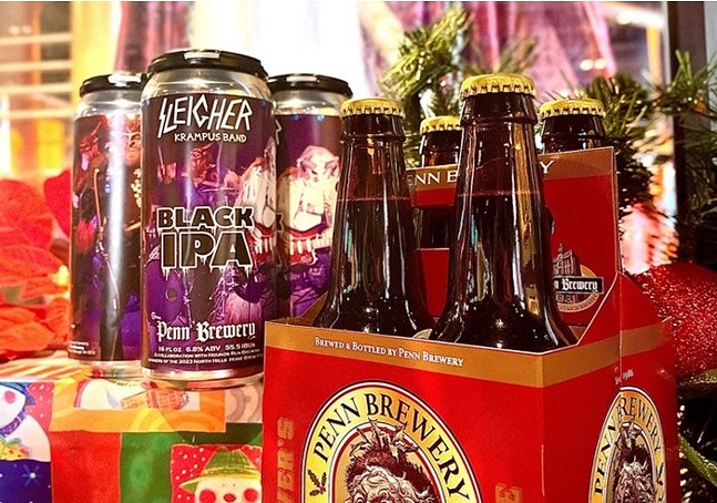 Cans and bottles of beer are pictured in festive winter holiday packaging.