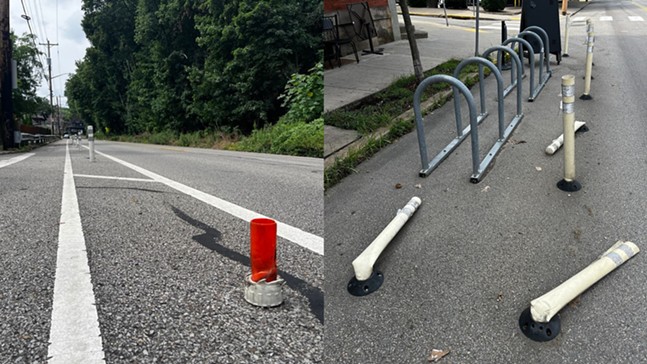An orange plastic stump where a FlexPost used to be and several smashed posts "protecting" a bike rack