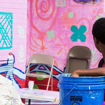 Kids work on a mural project in Homewood